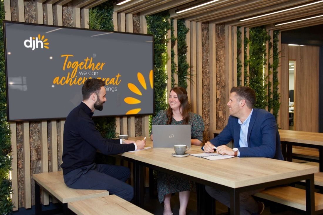 A meeting room with DJH branding
