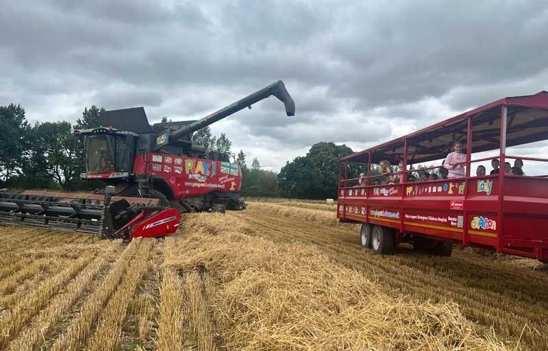 Farm machinery wrapped in PLAY@ branding